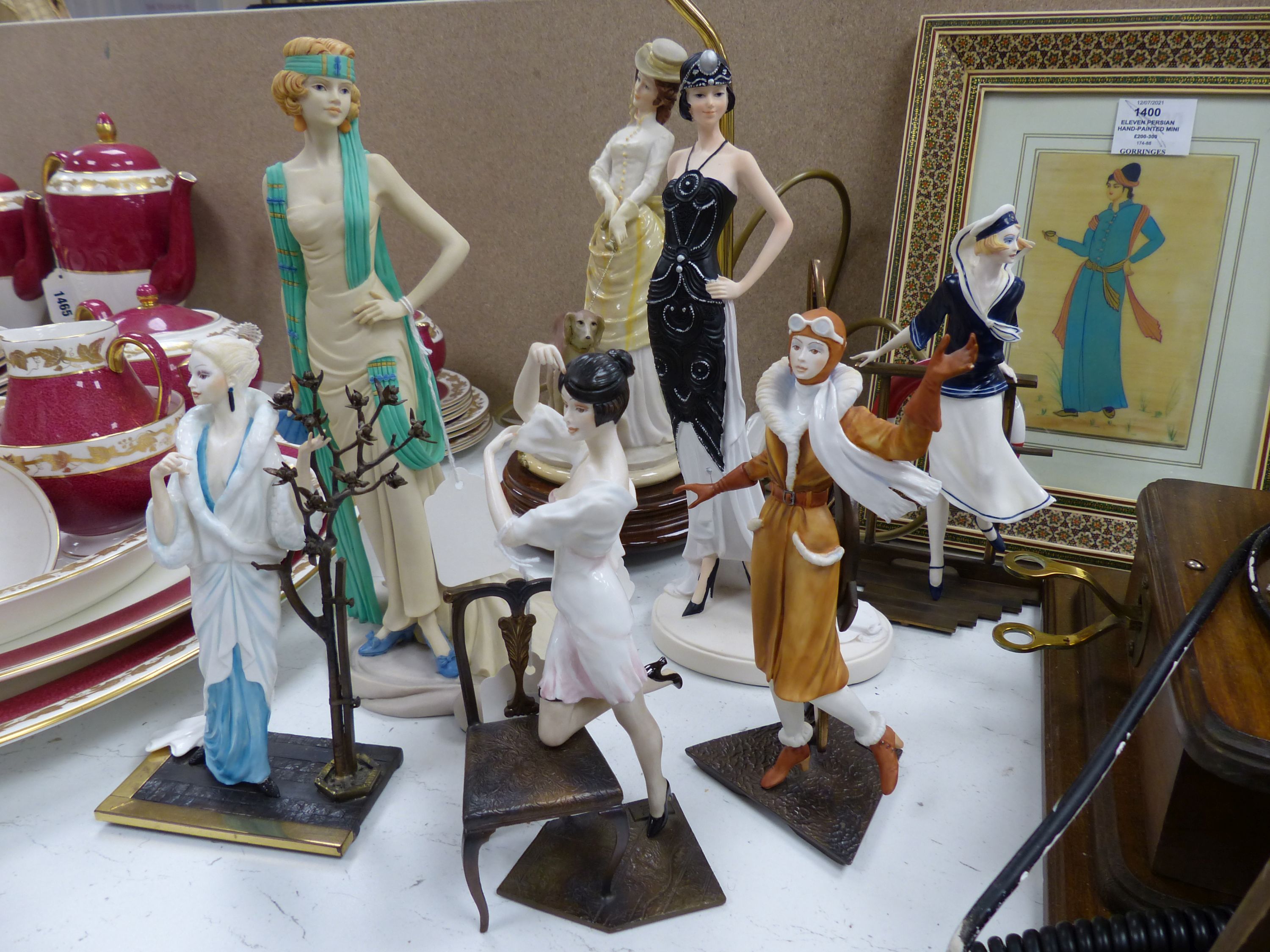 Four Albany bronzed metal and ceramic of elegant 1920's ladies, including 'Female Aviator', three other figures and a table lamp (8)